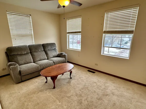 a view of a house with a small yard and wooden fence