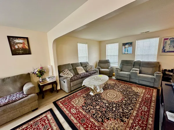 a living room with a couch and wooden floor