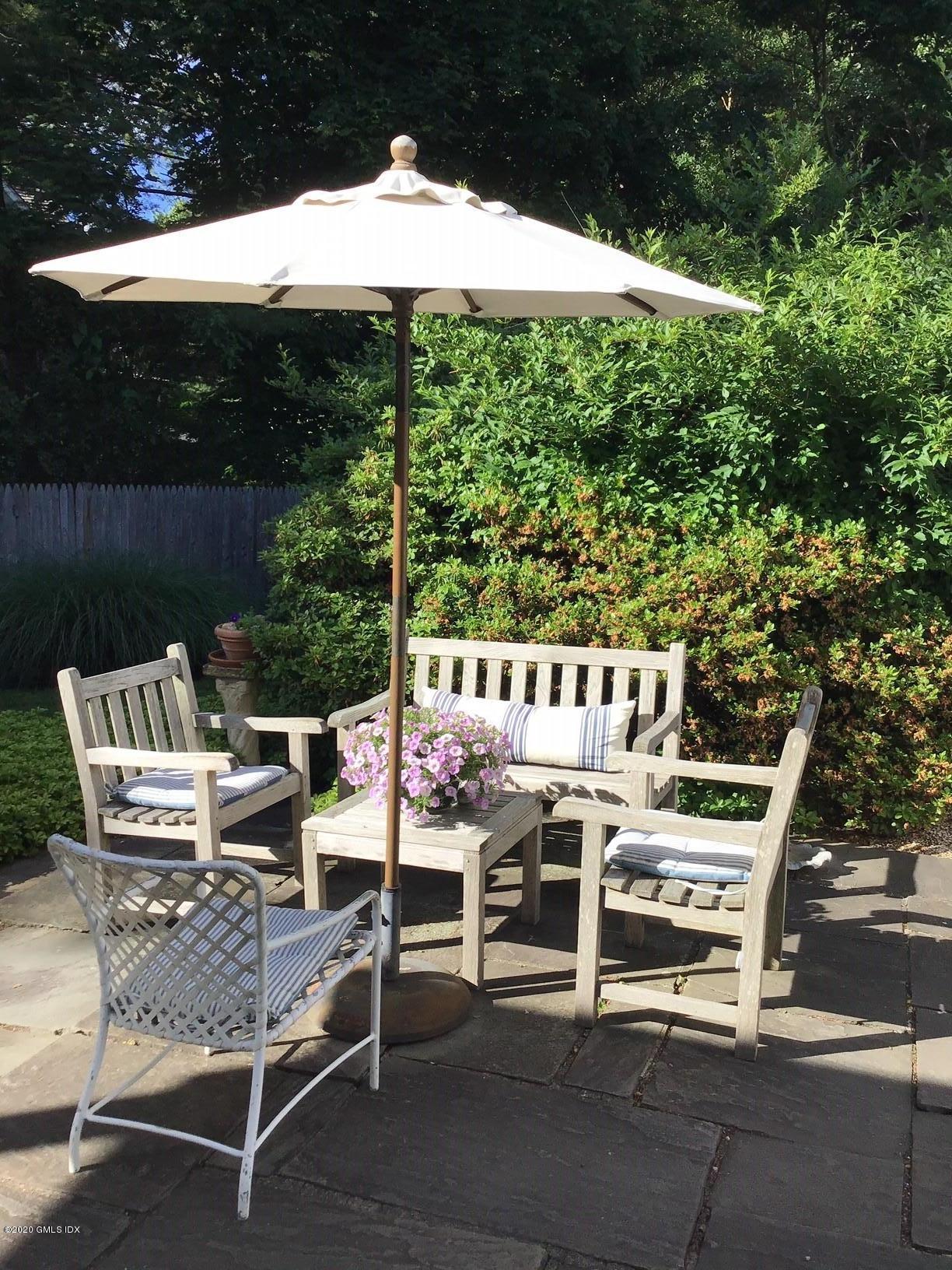 51 Hidden Brook Road Riverside, CT 06878 - Photo 4 of 4 a roof deck with table and chairs and potted plants