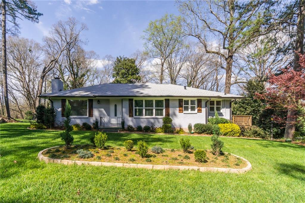 3584 Rockbridge Road Southwest Decatur, GA 30032 - Photo 1 of 1 a front view of a house with a yard table and chairs
