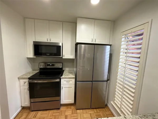 a kitchen with a refrigerator stove and microwave