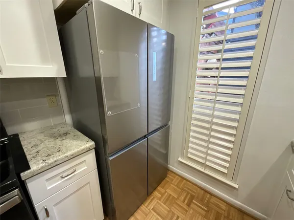 a kitchen with a refrigerator and a sink
