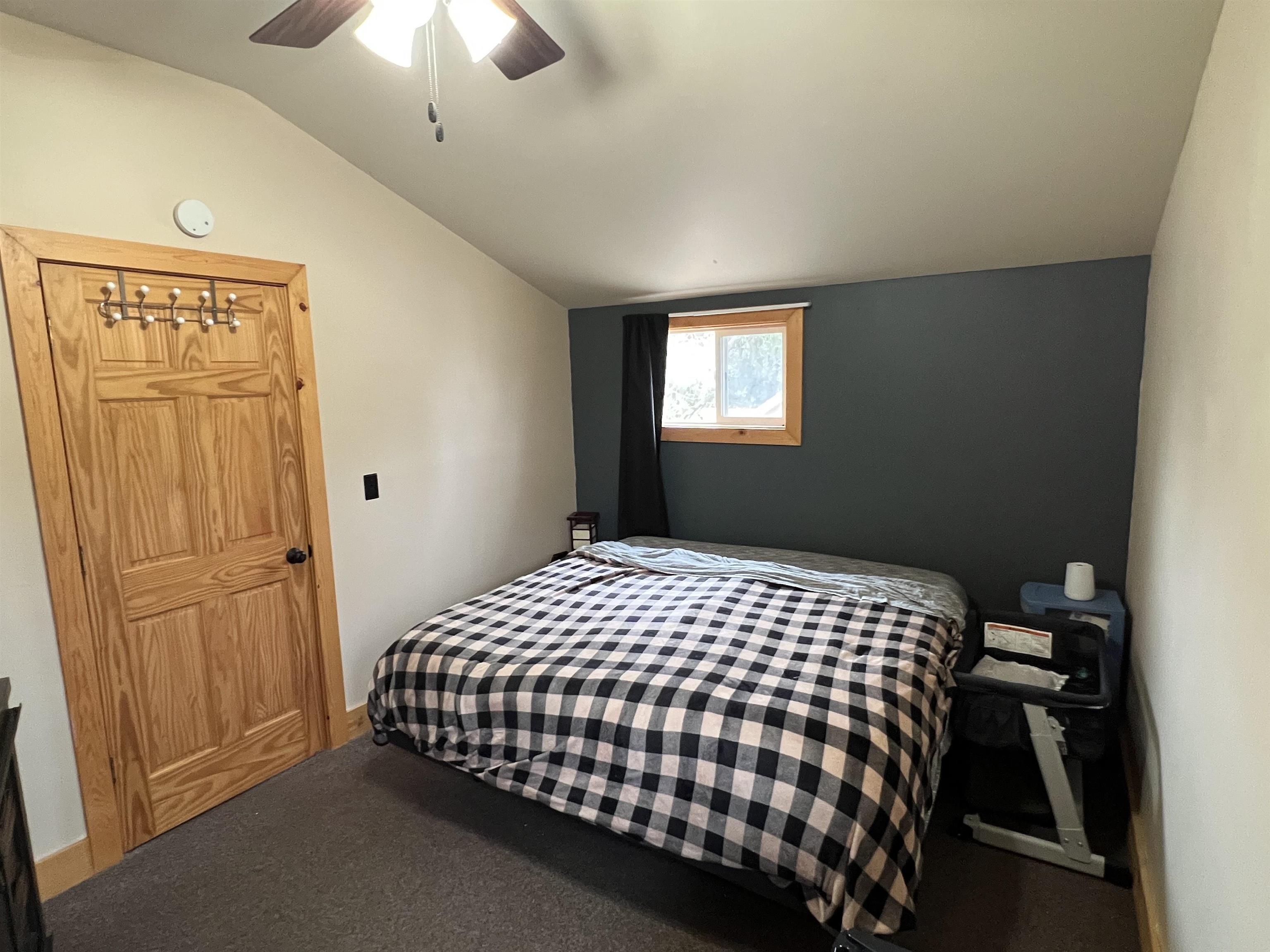 616 Cranston Road Beloit, WI 53511 - Photo 11 of 21 a bedroom with a bed and a chandelier