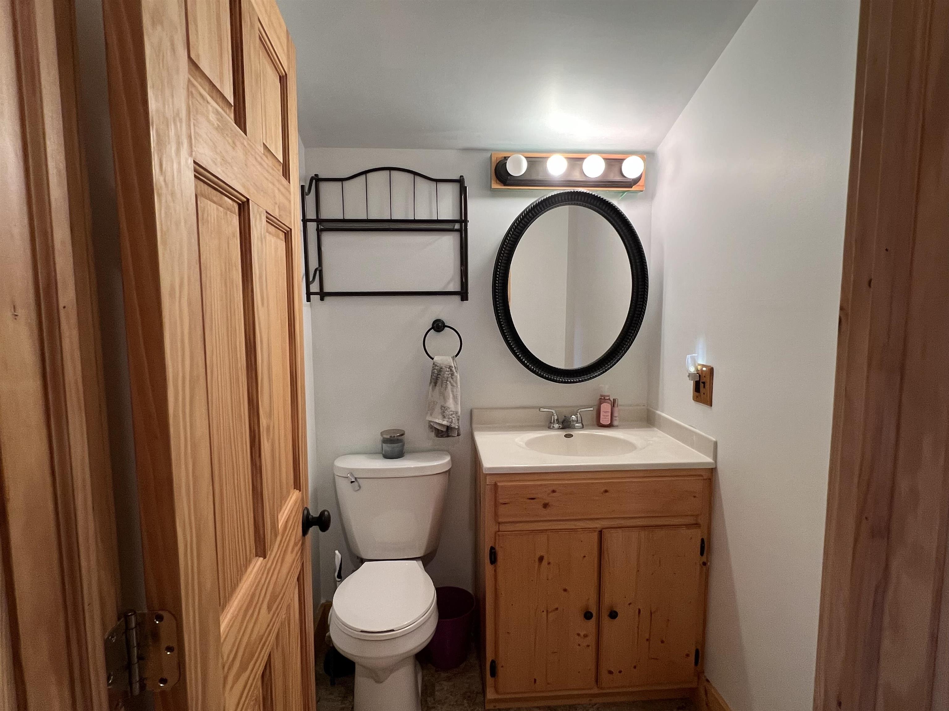 616 Cranston Road Beloit, WI 53511 - Photo 15 of 21 a bathroom with a toilet sink and a mirror
