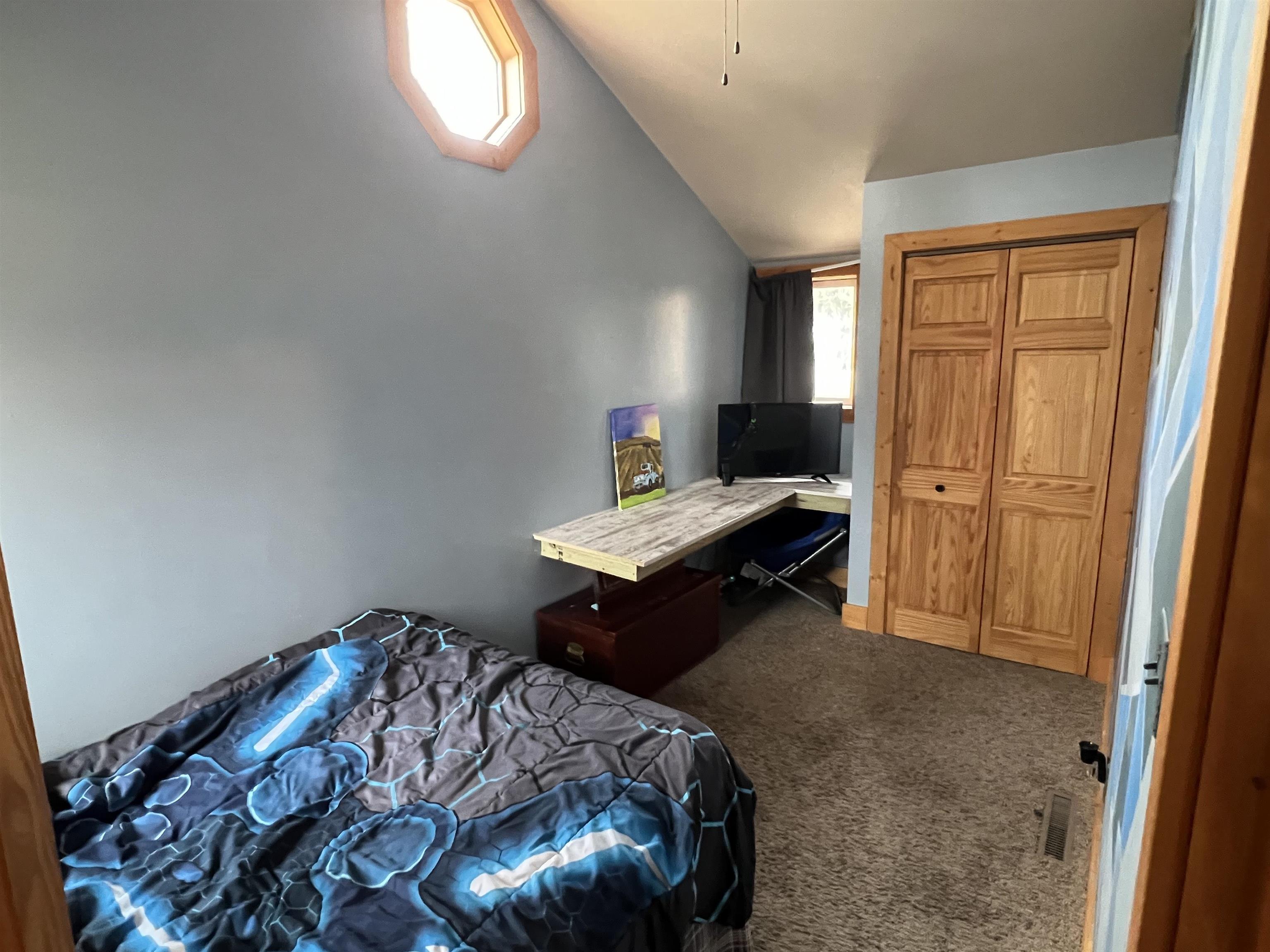 616 Cranston Road Beloit, WI 53511 - Photo 17 of 21 a bed sitting in a bedroom next to a window