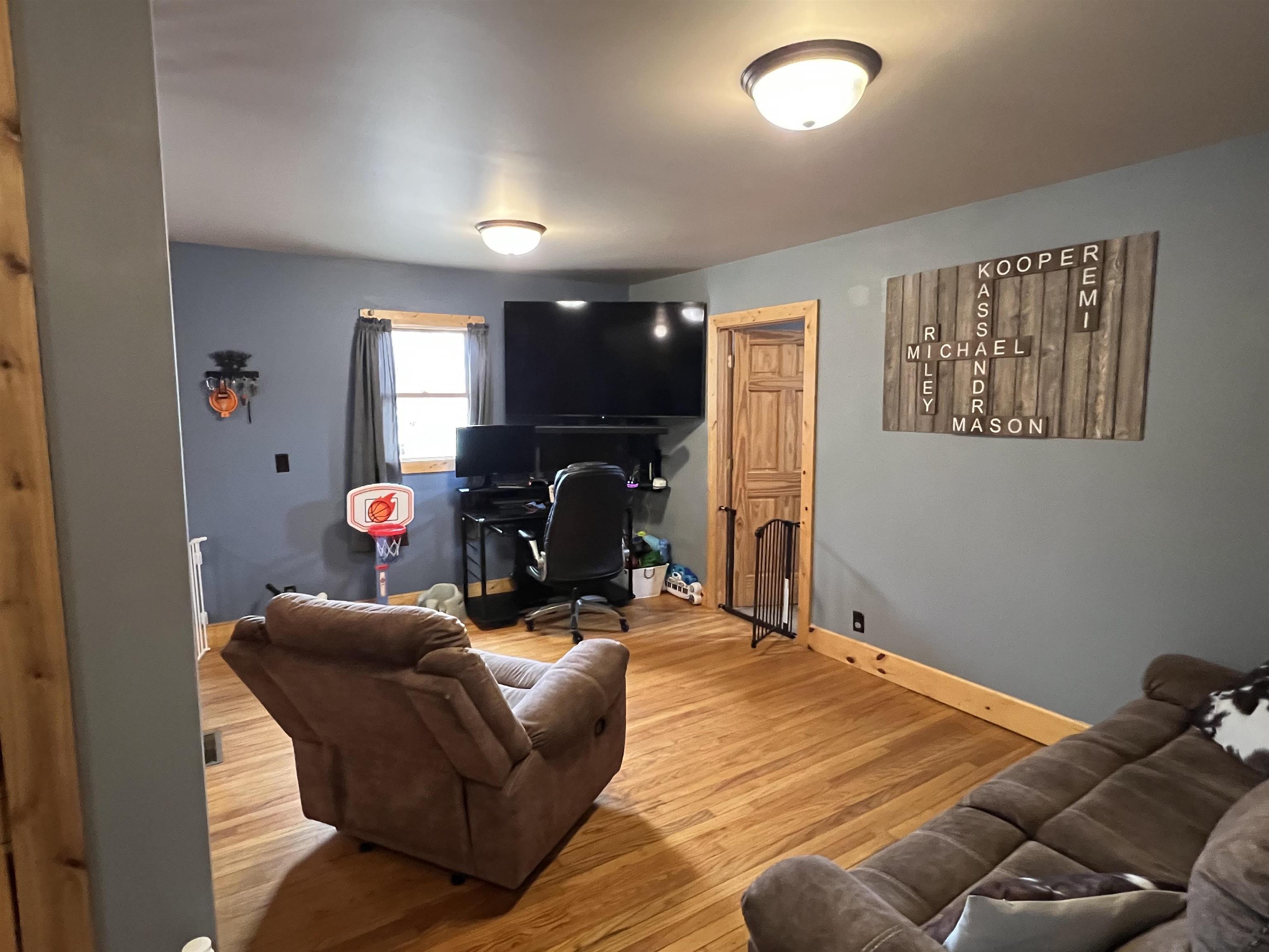 616 Cranston Road Beloit, WI 53511 - Photo 6 of 21 a bedroom with furniture and a fireplace
