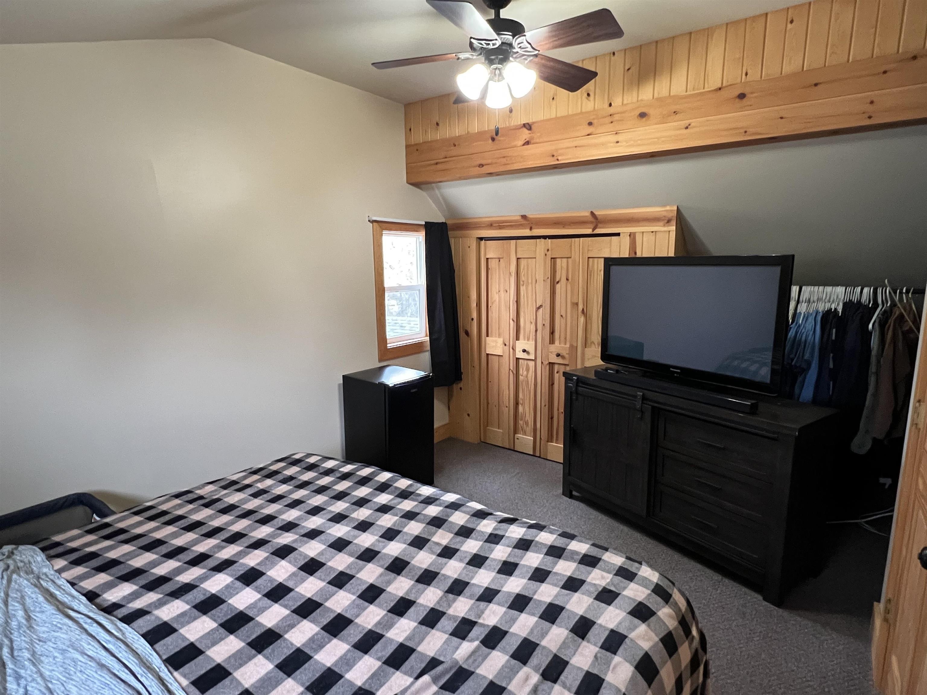 616 Cranston Road Beloit, WI 53511 - Photo 10 of 21 a bedroom with a bed and a flat tv screen on the dresser