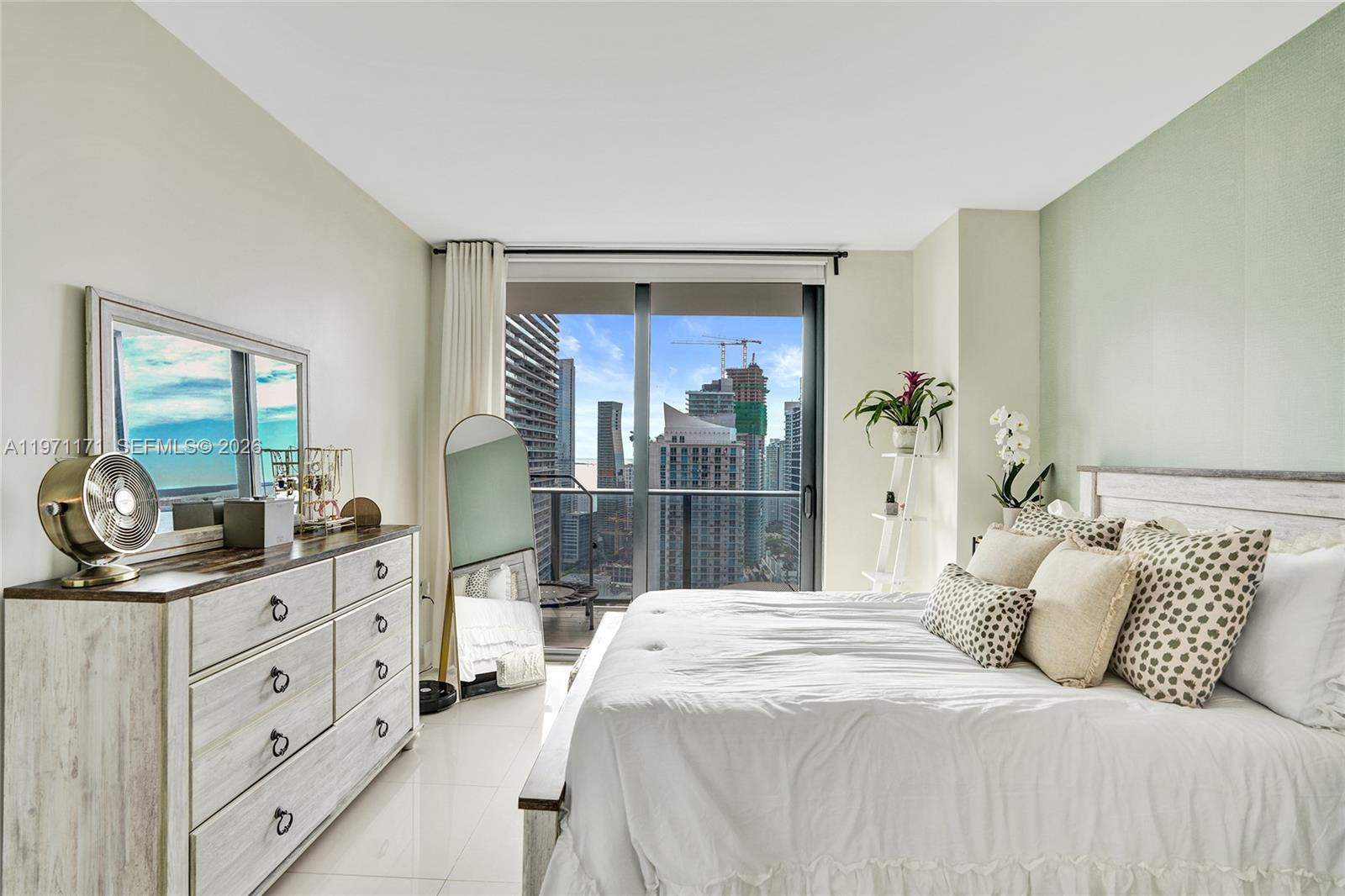 45 Southwest 9th Street, Unit 4004 Miami, FL 33130 - Photo 11 of 28 a bedroom with a large bed and a dresser