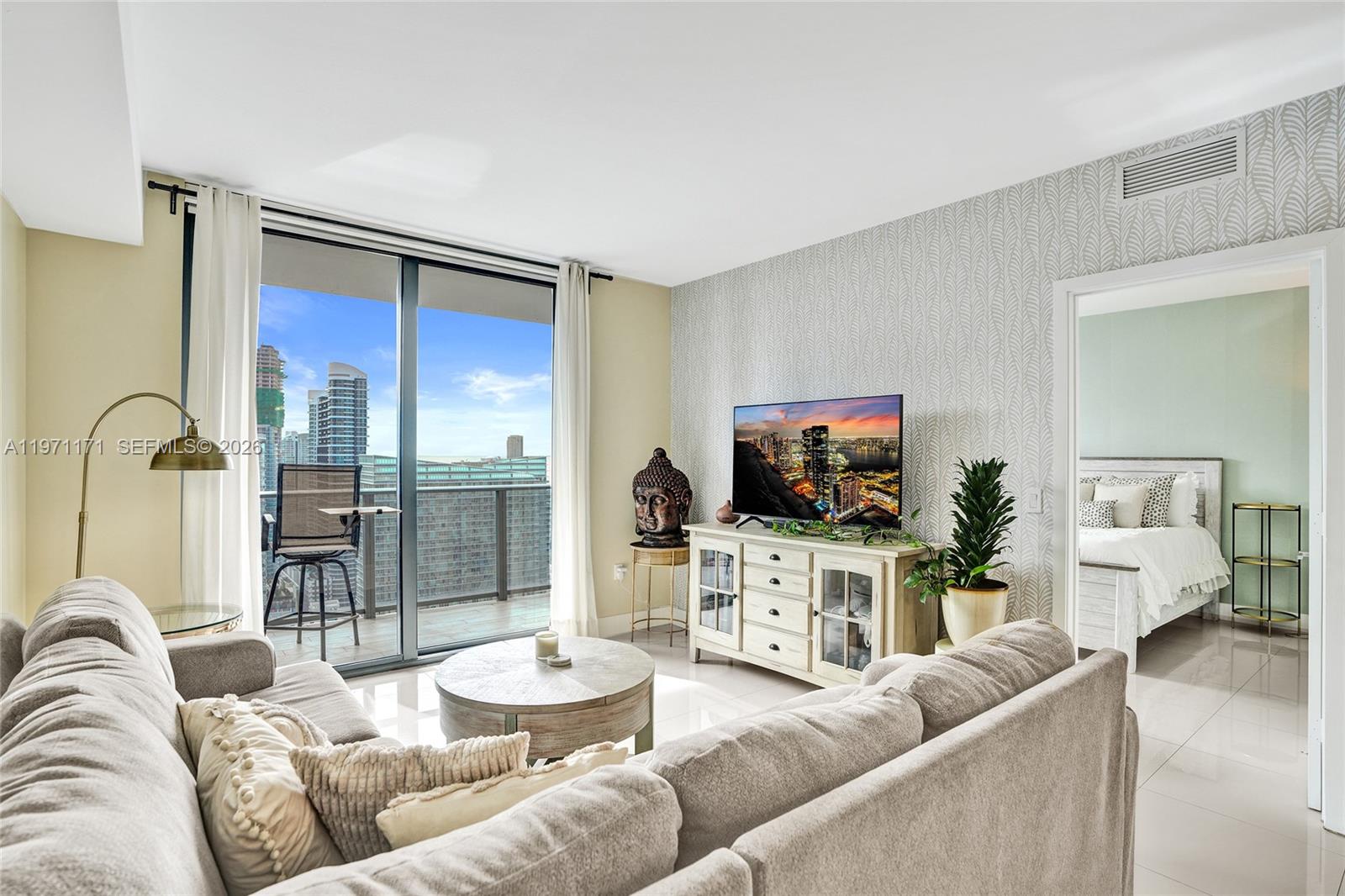 45 Southwest 9th Street, Unit 4004 Miami, FL 33130 - Photo 8 of 28 a living room with furniture and a flat screen tv