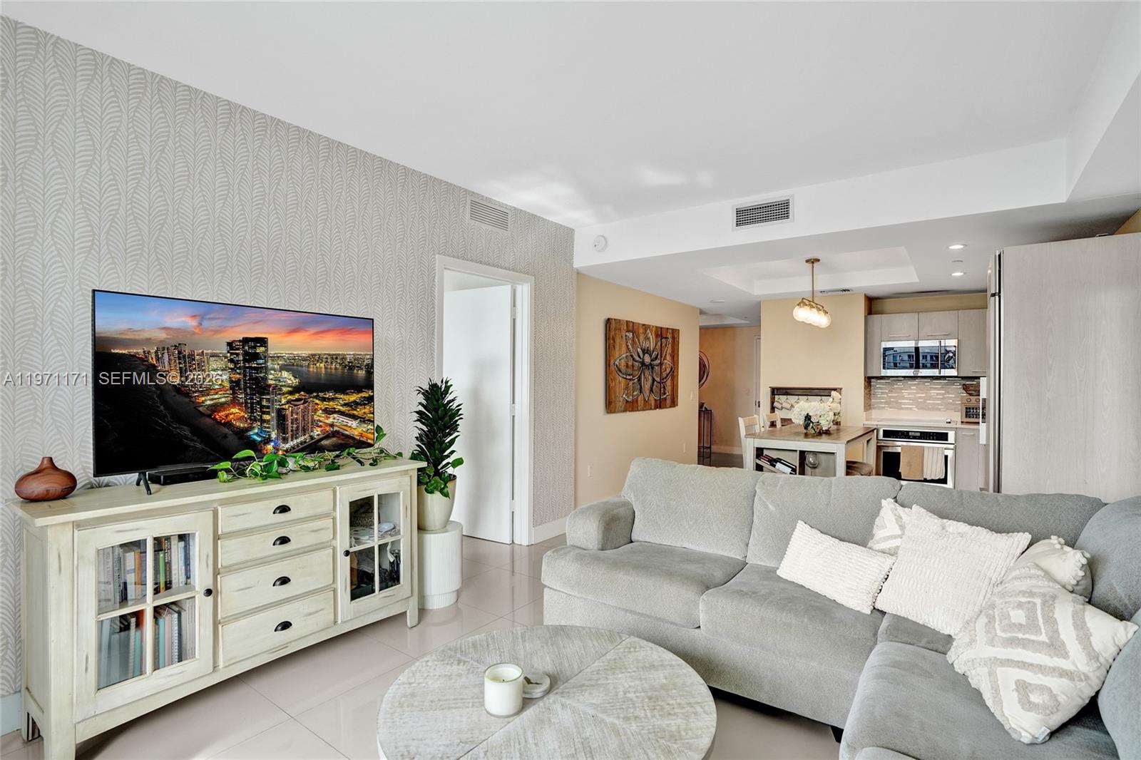 45 Southwest 9th Street, Unit 4004 Miami, FL 33130 - Photo 9 of 28 a living room with furniture and a flat screen tv