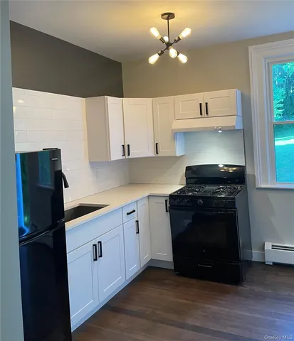 a kitchen with stainless steel appliances granite countertop a stove a refrigerator and a sink