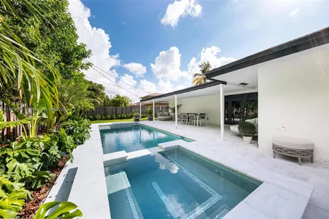 a view of a living room and kitchen