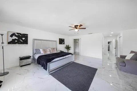a spacious bedroom with a bed and a view of bathroom