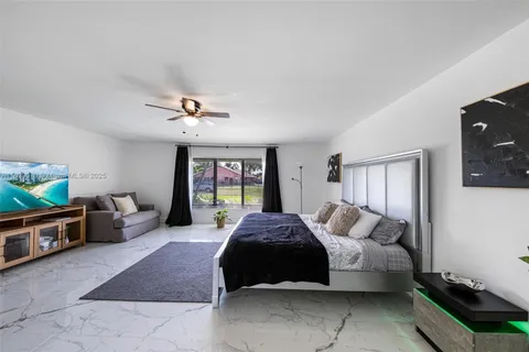 a bedroom with a bed couch and window