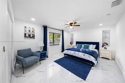 a bedroom with a bed couch and window