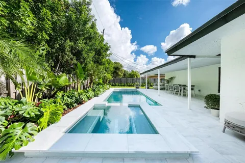 a view of a swimming pool with a table and chairs