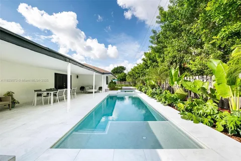 a view of a swimming pool with a lounge chair