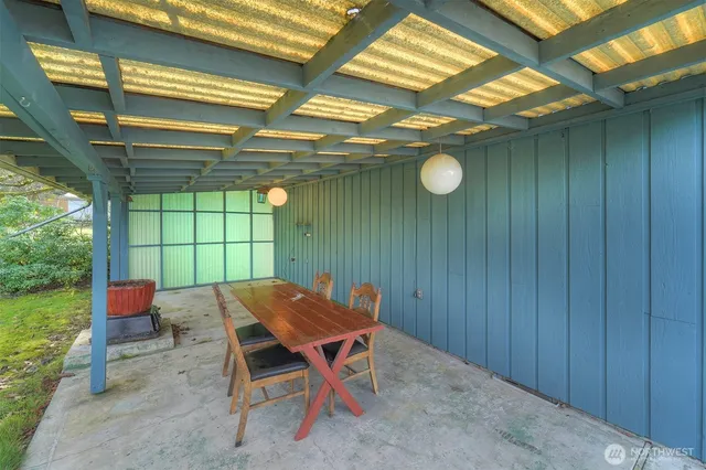 a backyard of a house with lots of green space and chair