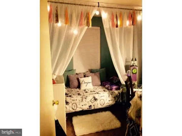 a view of a living room with a table and chairs