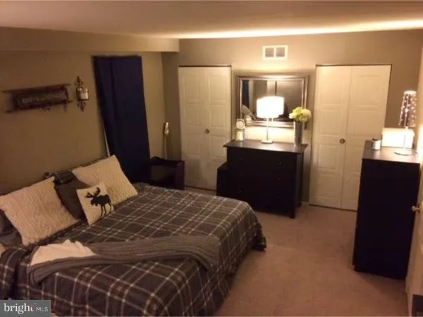 a bedroom with a bed and mirror