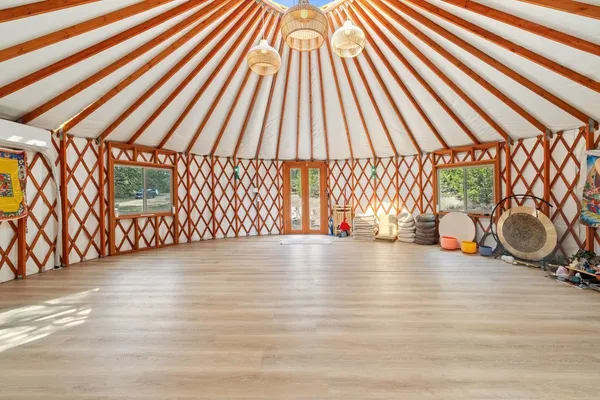 a view of a room with wooden floor and fence