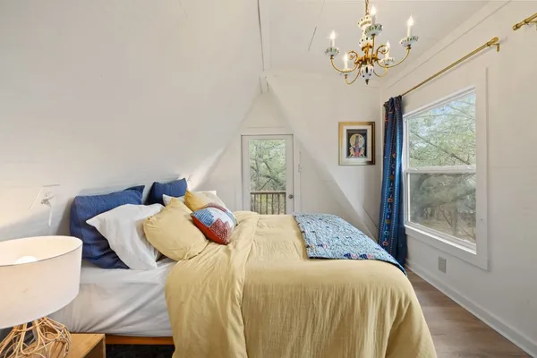 a bedroom with a bed a lamp and a window