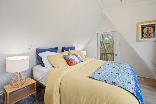 a bedroom with a large bed and a chandelier