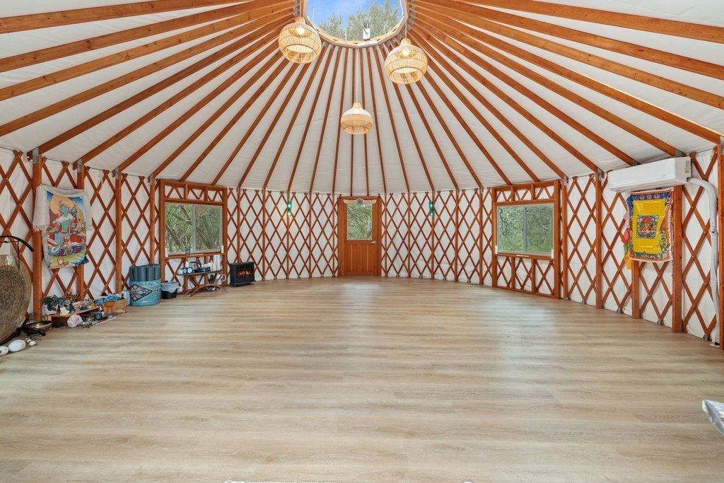 321 Lea Lane Wimberley, TX 78676 - Photo 17 of 39 Miscellaneous room featuring light wood-type flooring, healthy amount of natural light, and beam ceiling