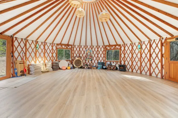 a view of a room with wooden floor and white walls