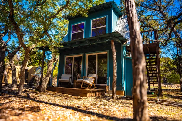 a view of a house with backyard porch and sitting area