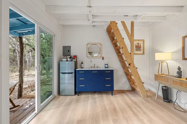 a view of a bedroom with furniture staircase and front door