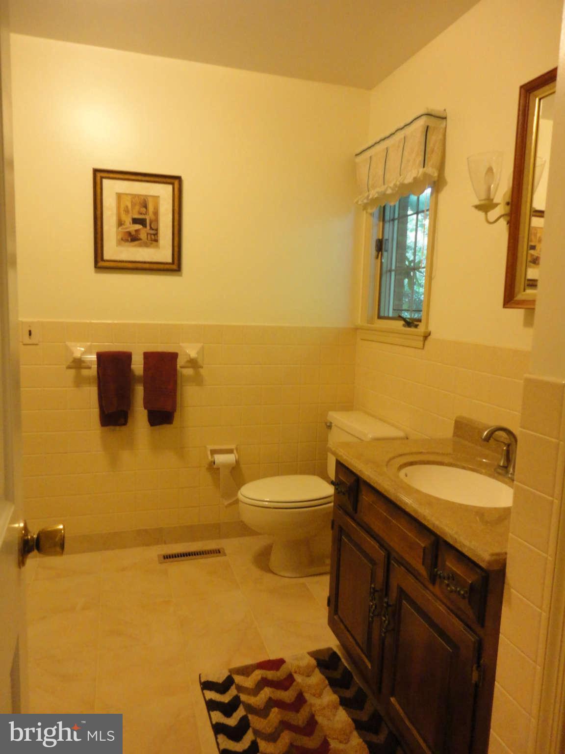 12915 Gent Road Reisterstown, MD 21136 - Photo 18 of 29 a bathroom with a granite countertop toilet sink and mirror
