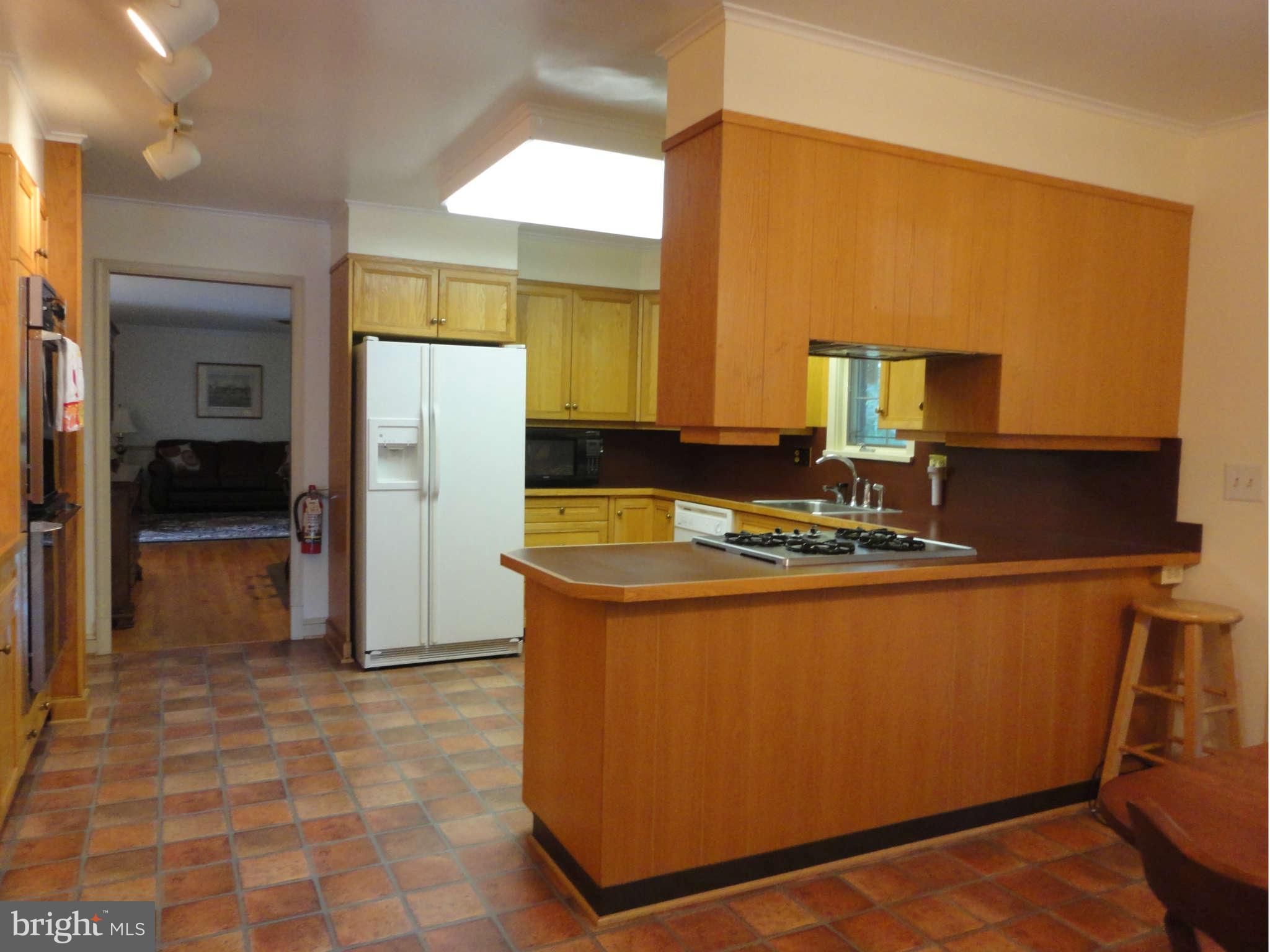 12915 Gent Road Reisterstown, MD 21136 - Photo 5 of 29 a kitchen with stainless steel appliances granite countertop a refrigerator and a stove
