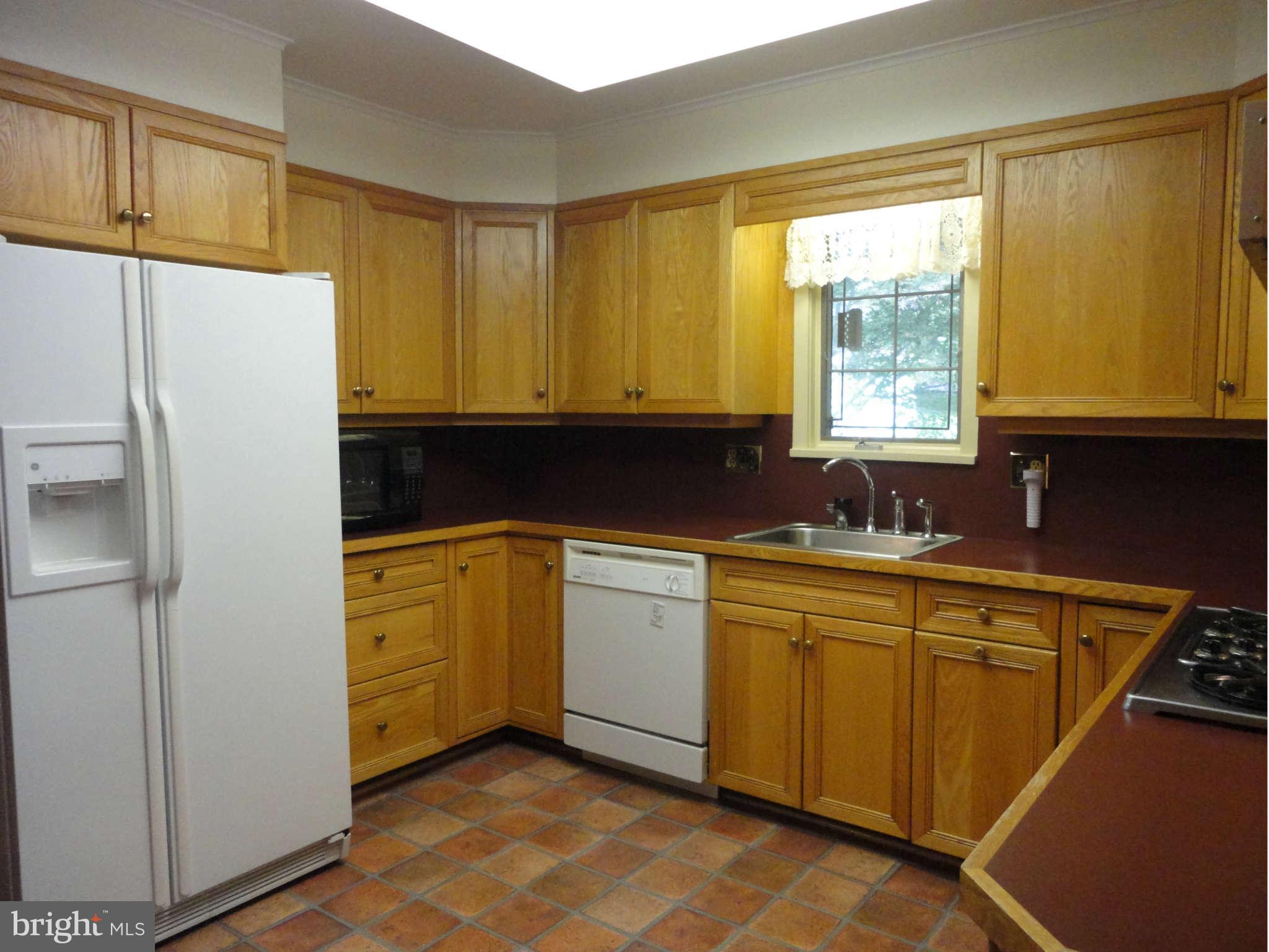 12915 Gent Road Reisterstown, MD 21136 - Photo 8 of 29 a kitchen with a refrigerator sink and cabinets