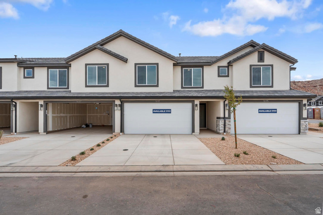 Modern stucco exteriors featuring dark trim windows and a stone accent facade