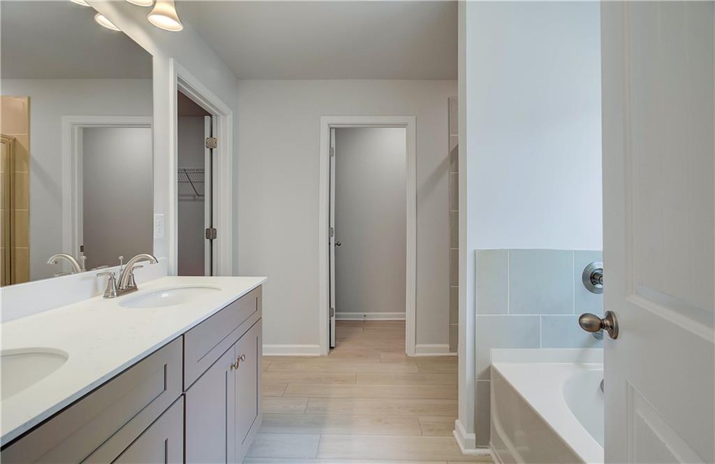 117 Alpine Road Fairburn, GA 30213 - Photo 22 of 29 a bathroom with a tub sink and mirror