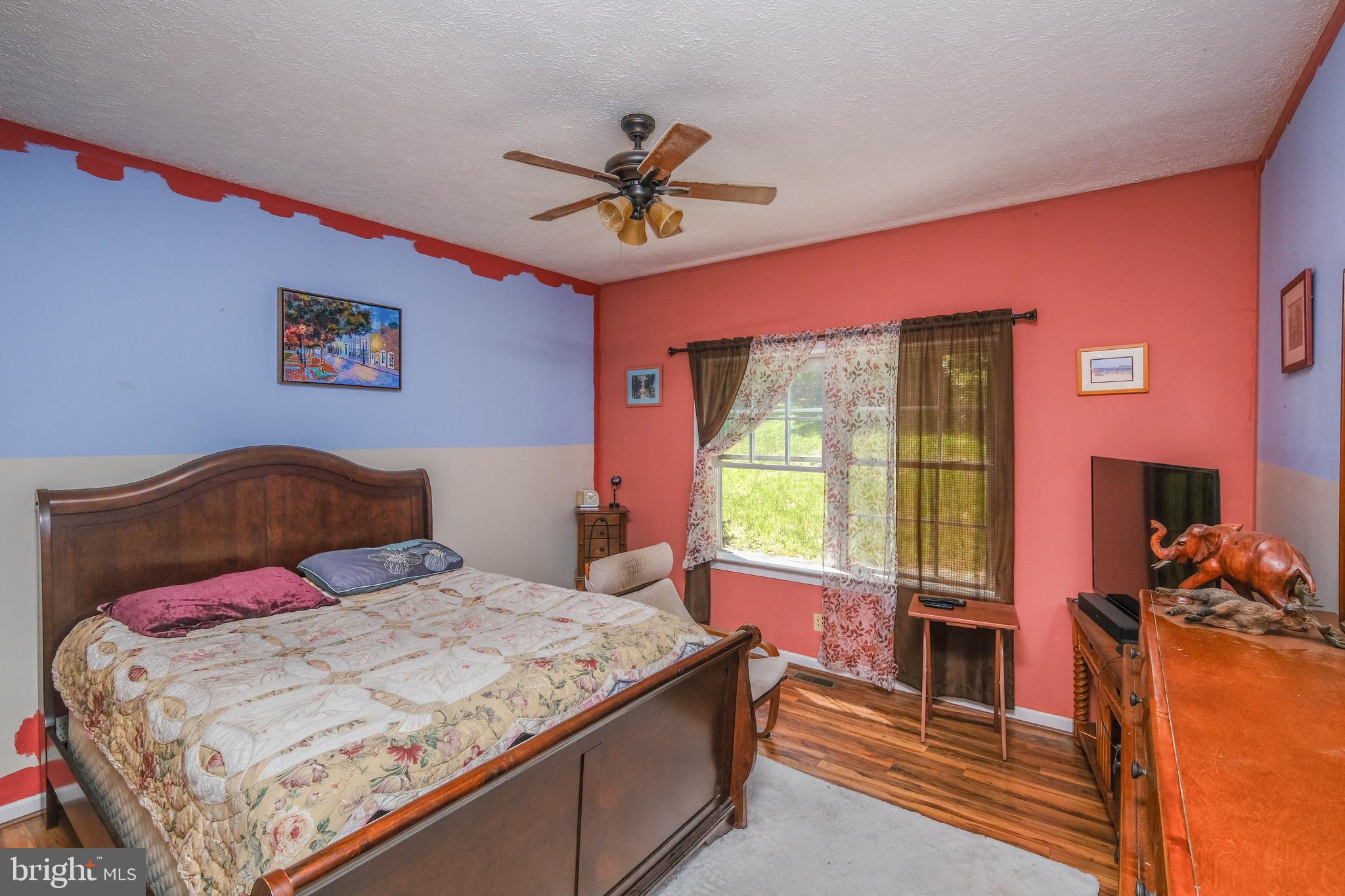 1195 Shangri-La Road Bentonville, VA 22610 - Photo 54 of 64 a bedroom with a bed and a chandelier