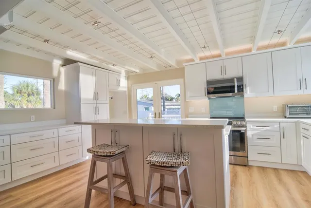 a spacious bathroom with a granite countertop sink and a large mirror
