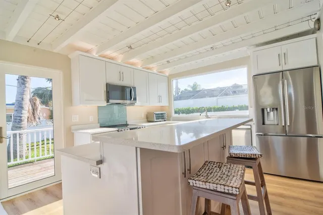 a living room with furniture a dining table and a fireplace
