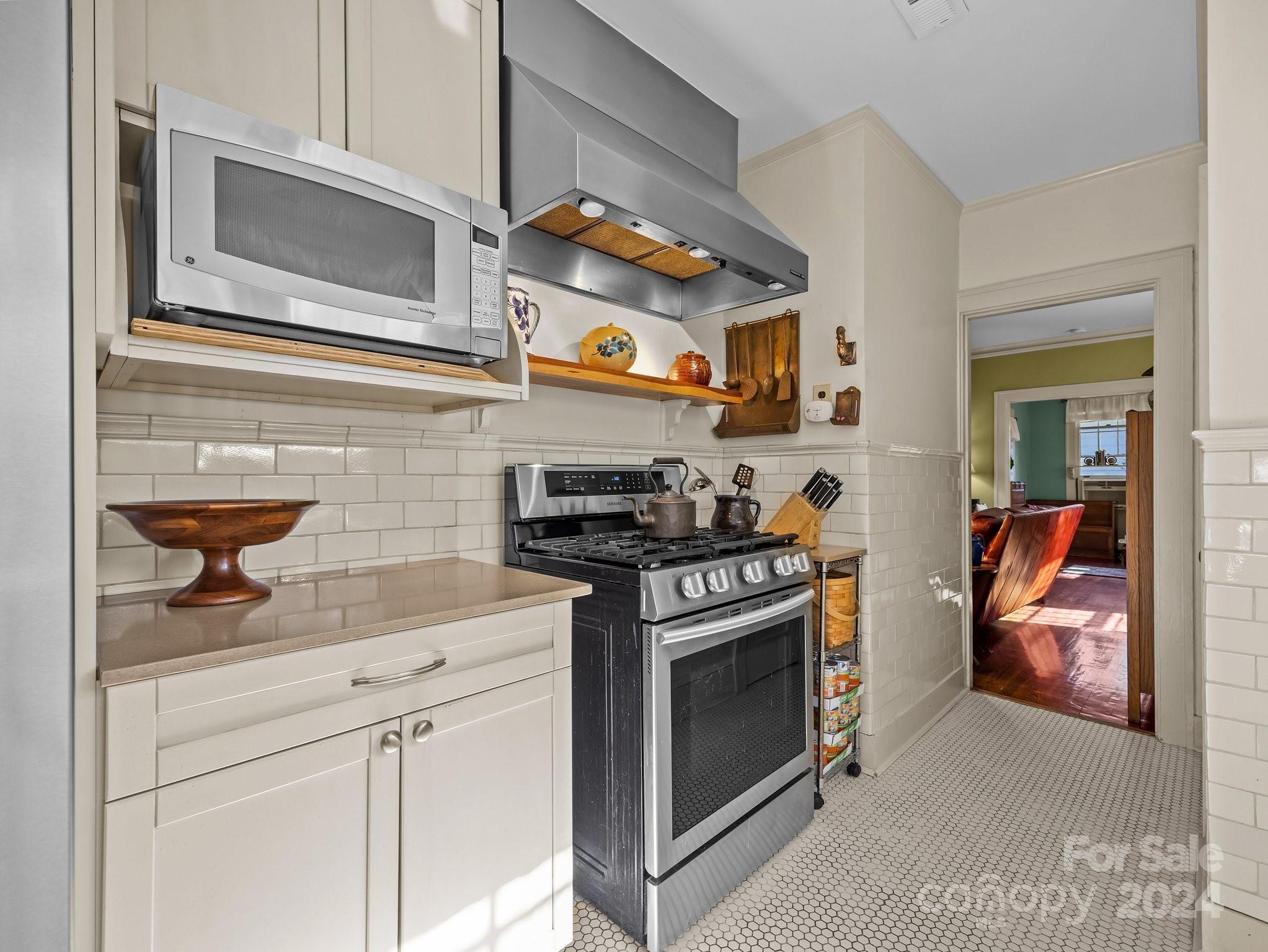 100 Edwin Place Asheville, NC 28801 - Photo 11 of 35 a kitchen with stainless steel appliances granite countertop a stove and a microwave