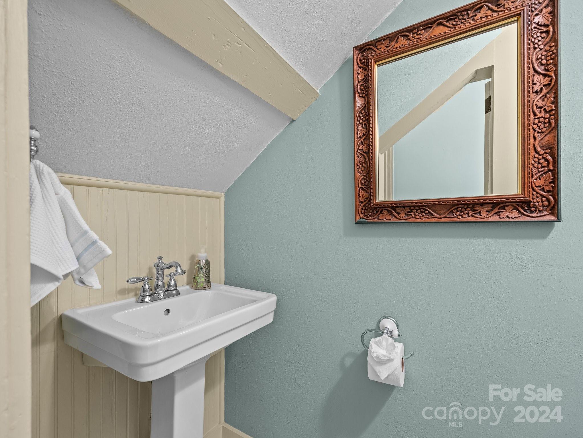 100 Edwin Place Asheville, NC 28801 - Photo 15 of 35 a bathroom with a sink a mirror and a toilet