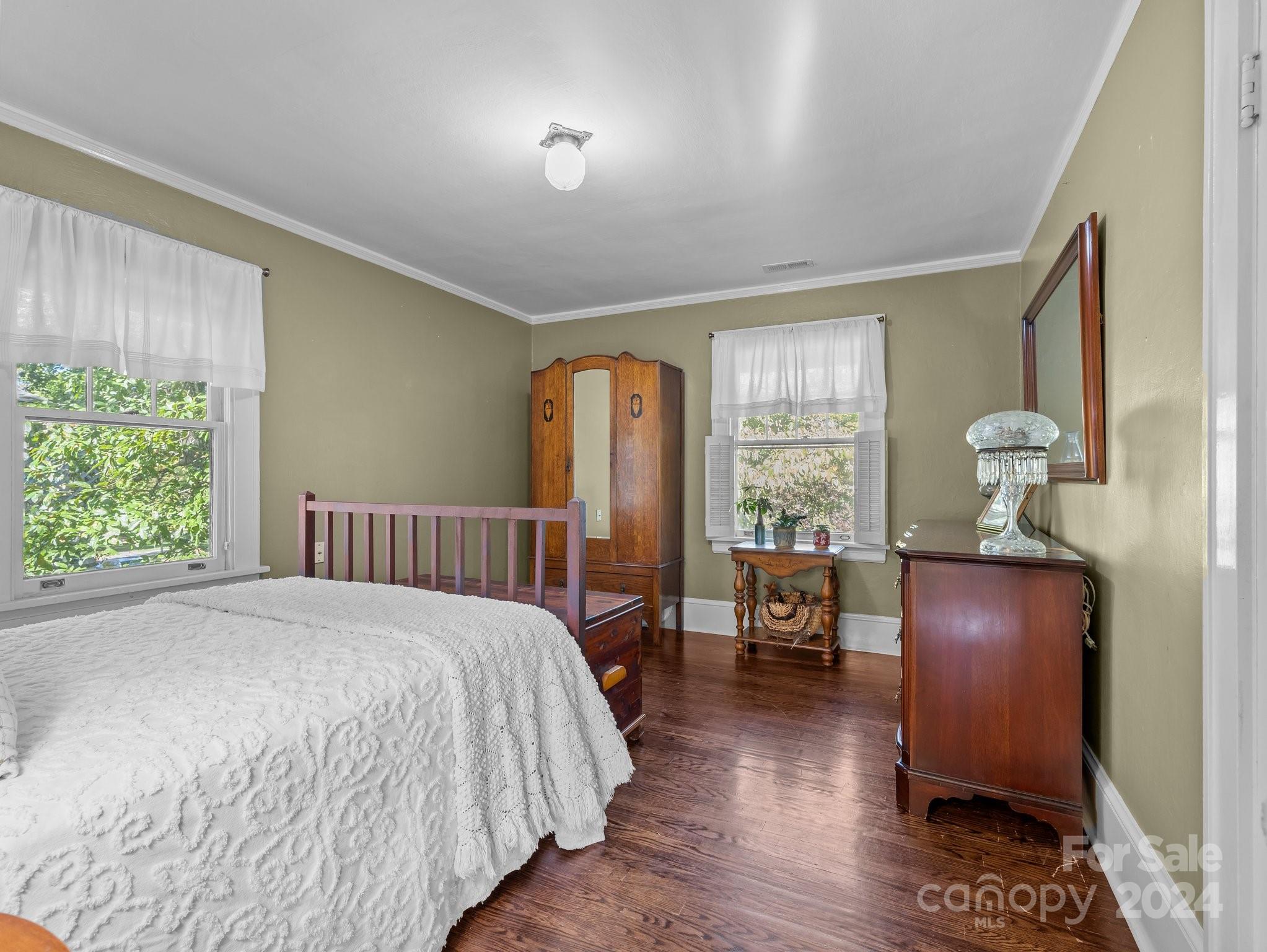 100 Edwin Place Asheville, NC 28801 - Photo 18 of 35 a bedroom with a bed and wooden floor