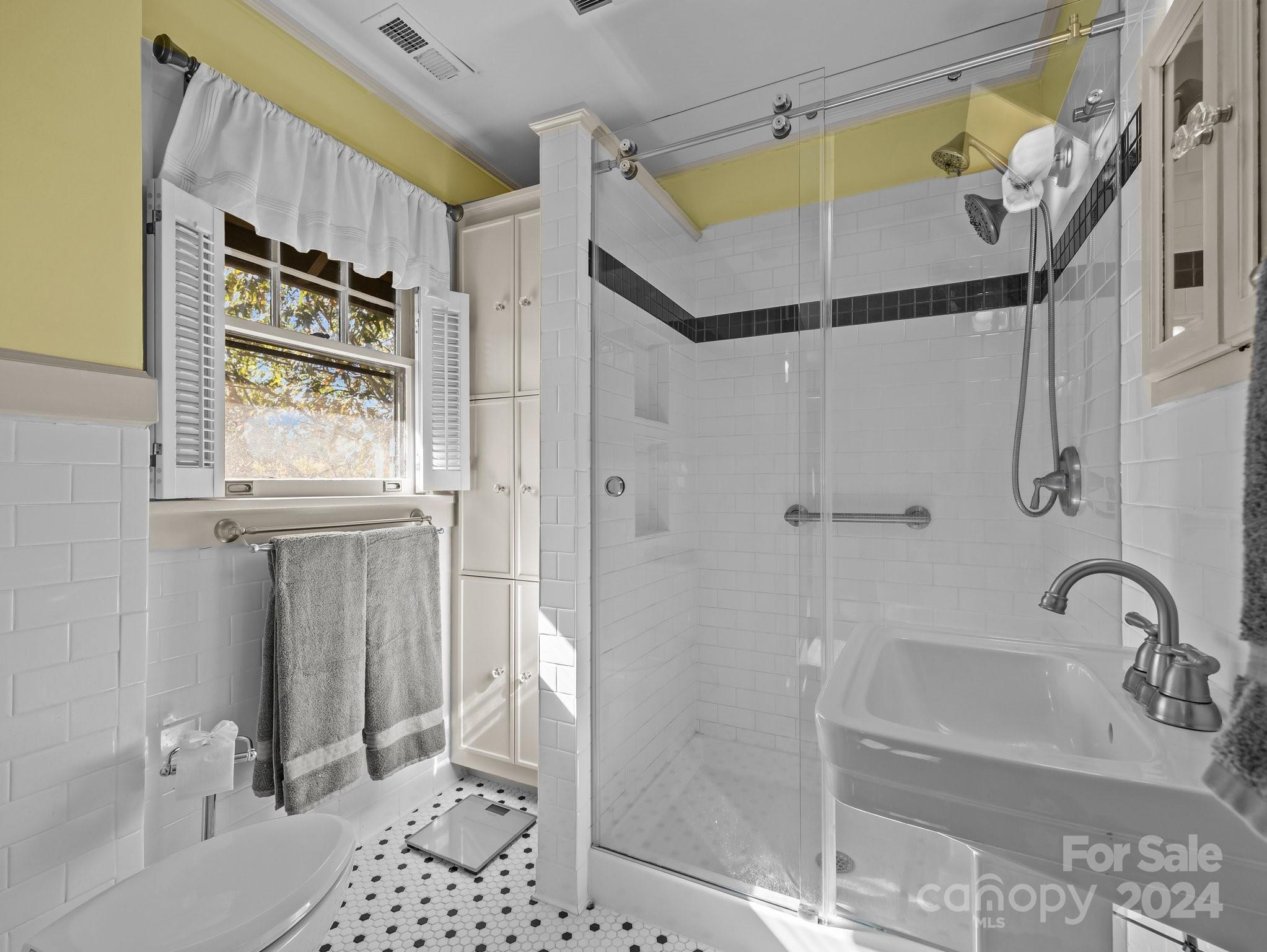 100 Edwin Place Asheville, NC 28801 - Photo 19 of 35 a bathroom with a shower and a sink