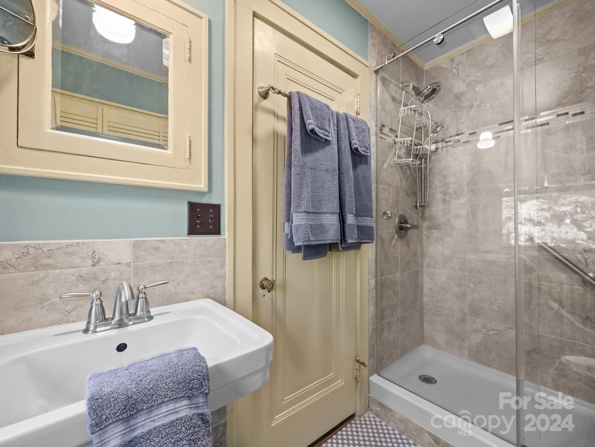 100 Edwin Place Asheville, NC 28801 - Photo 25 of 35 a bathroom with a tub and a shower
