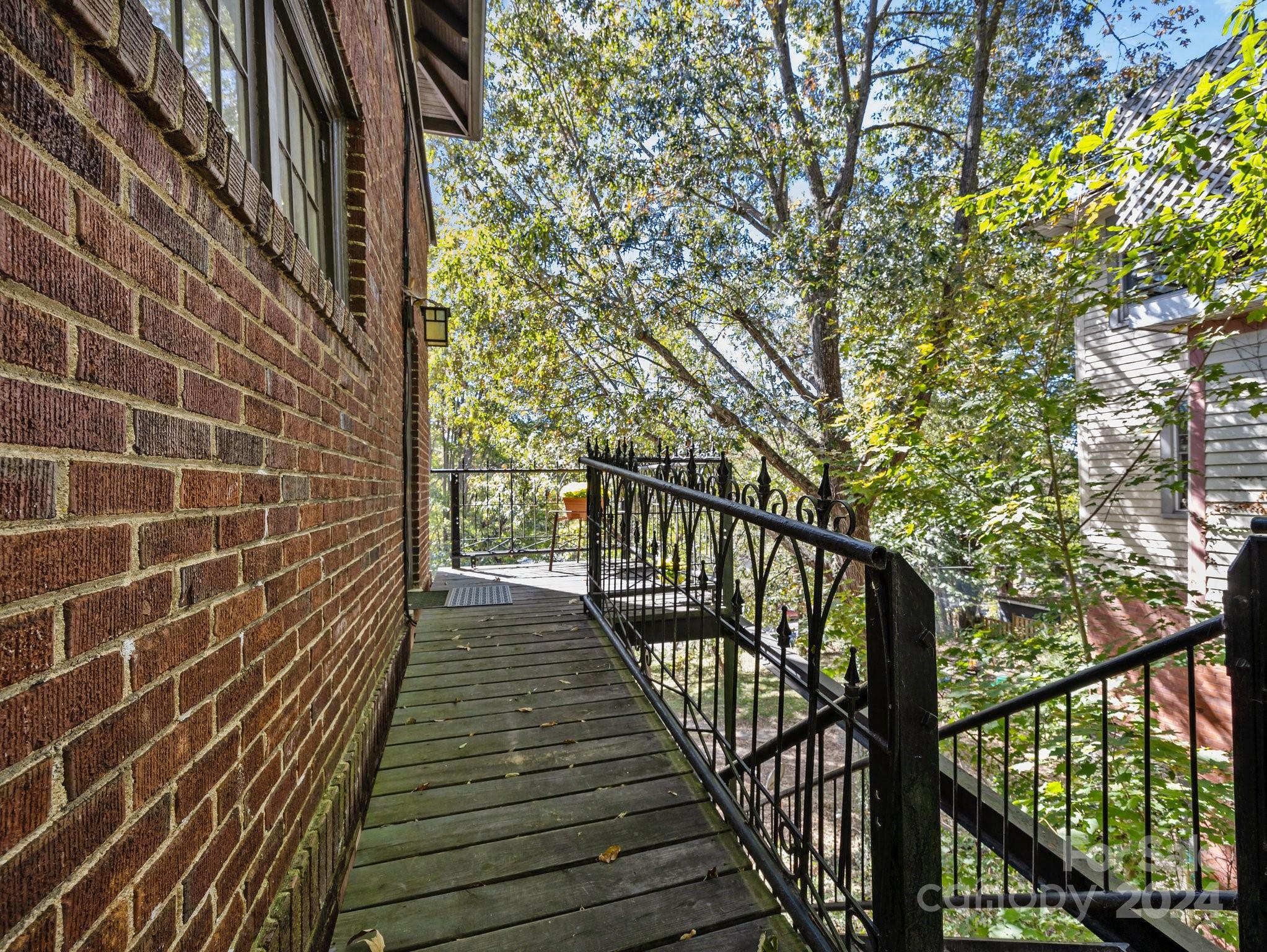 100 Edwin Place Asheville, NC 28801 - Photo 32 of 35 a view of balcony with wooden floor and fence