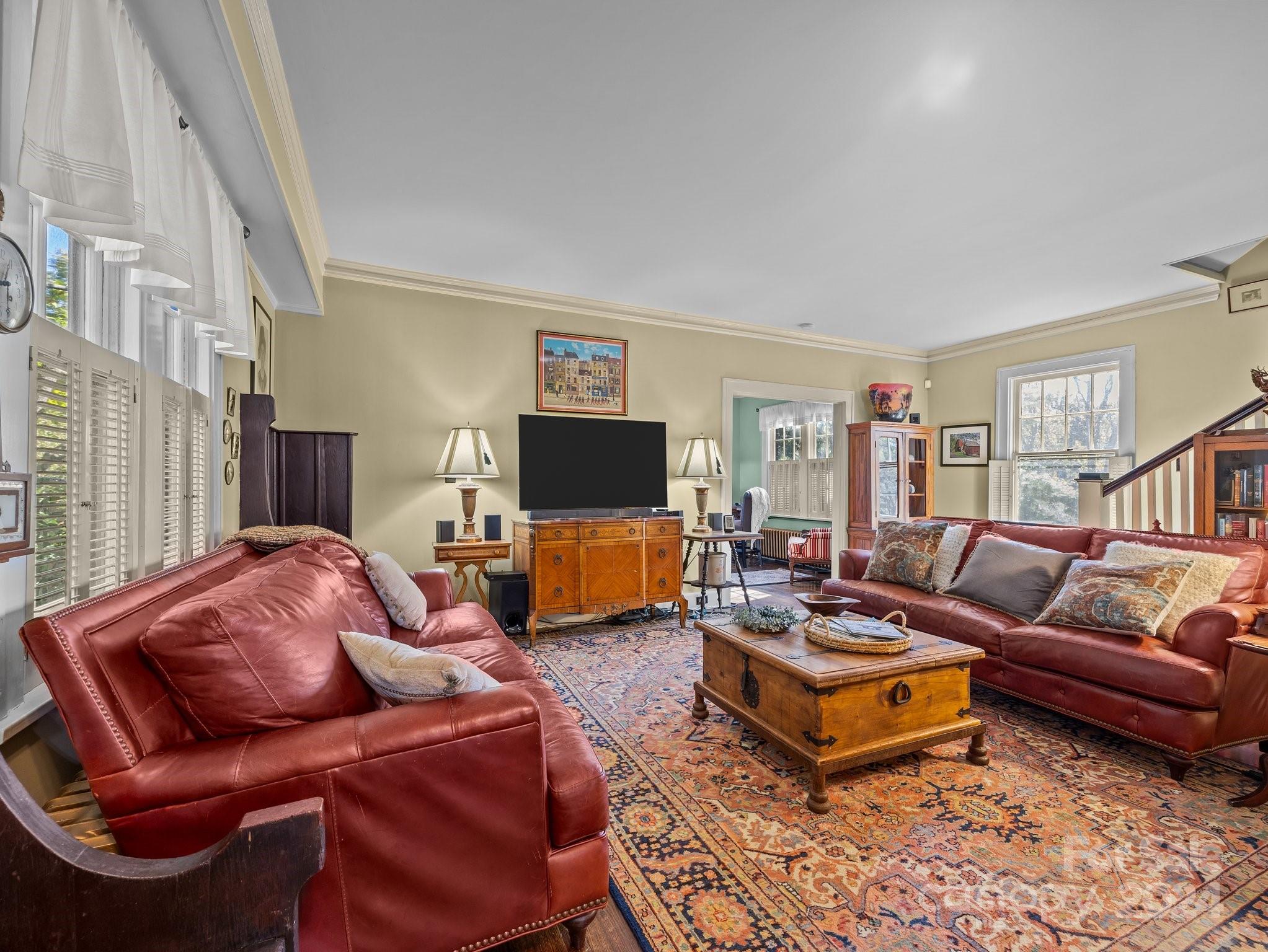 100 Edwin Place Asheville, NC 28801 - Photo 4 of 35 a living room with furniture a flat screen tv and a fireplace