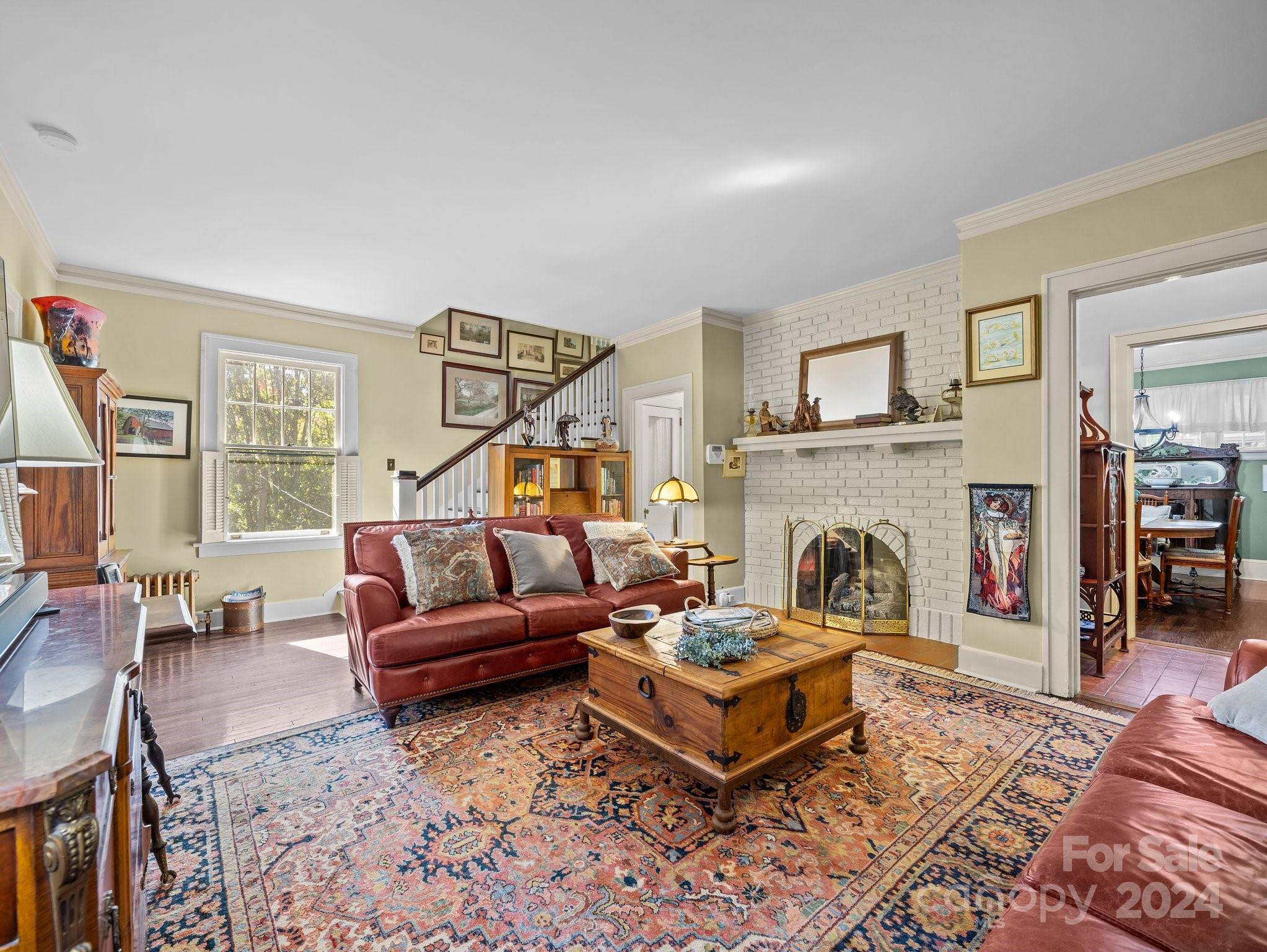 100 Edwin Place Asheville, NC 28801 - Photo 5 of 35 a living room with furniture a flat screen tv and a fireplace