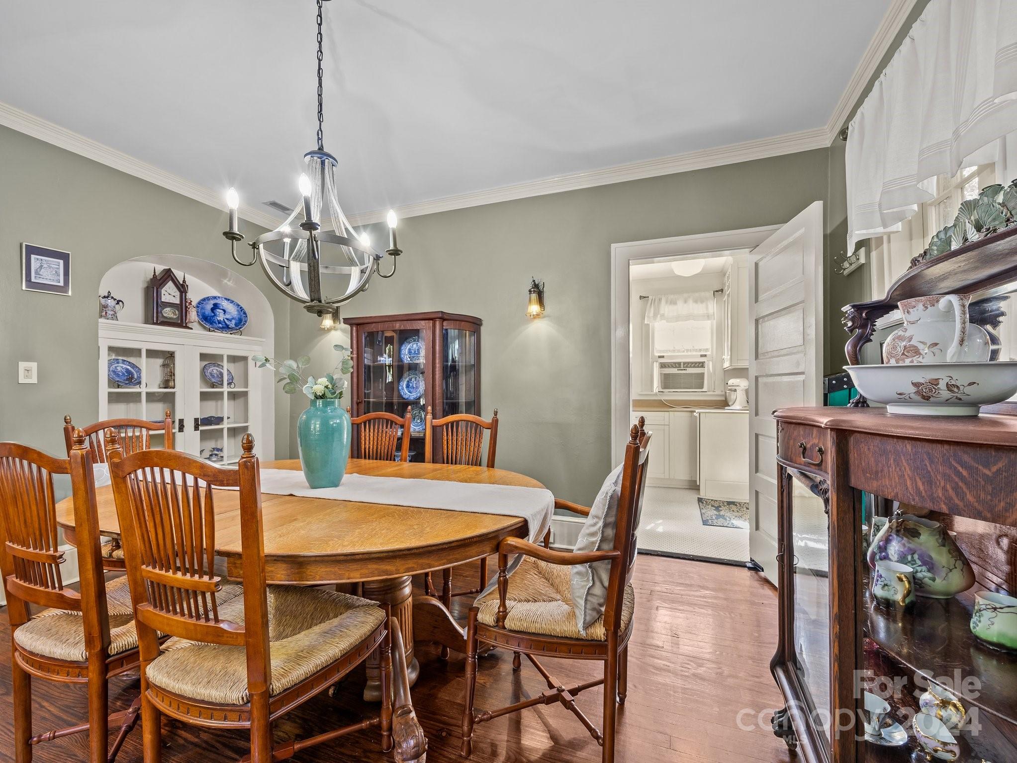 100 Edwin Place Asheville, NC 28801 - Photo 9 of 35 a view of a dining room with furniture a chandelier and wooden floor