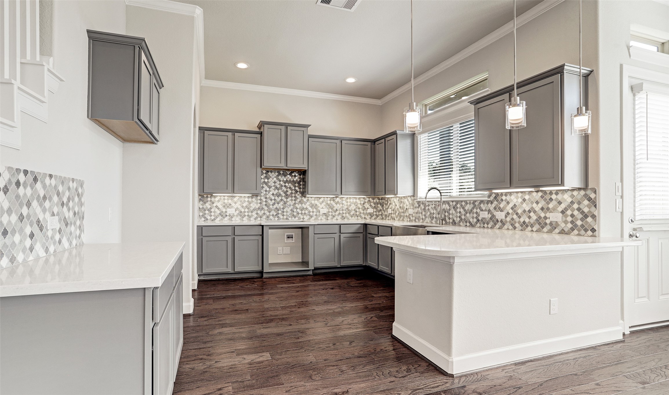 136 Peninsula Point Drive Montgomery, TX 77356 - Photo 20 of 36 a kitchen with kitchen island white cabinets and sink