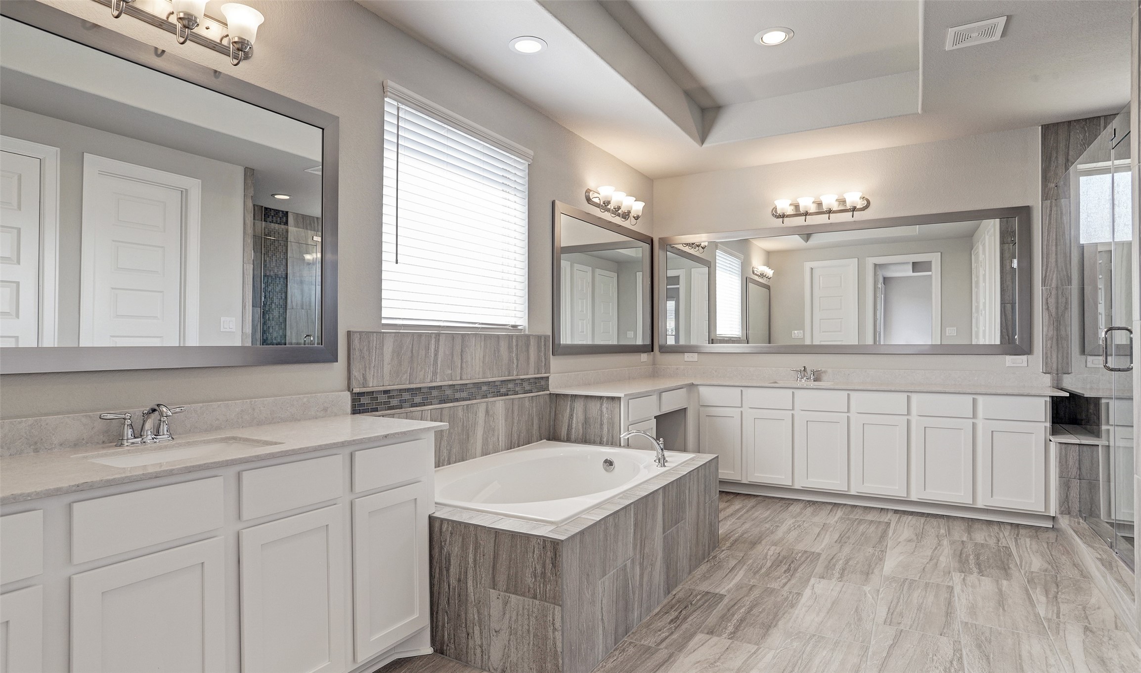 136 Peninsula Point Drive Montgomery, TX 77356 - Photo 24 of 36 a bathroom with a sink vanity granite tub and a mirror